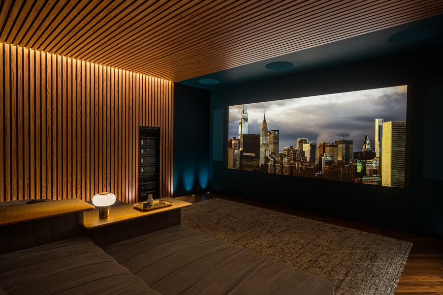 Luxury home theater with a wood-paneled accent wall, recessed lighting, and a large screen displaying a city skyline.